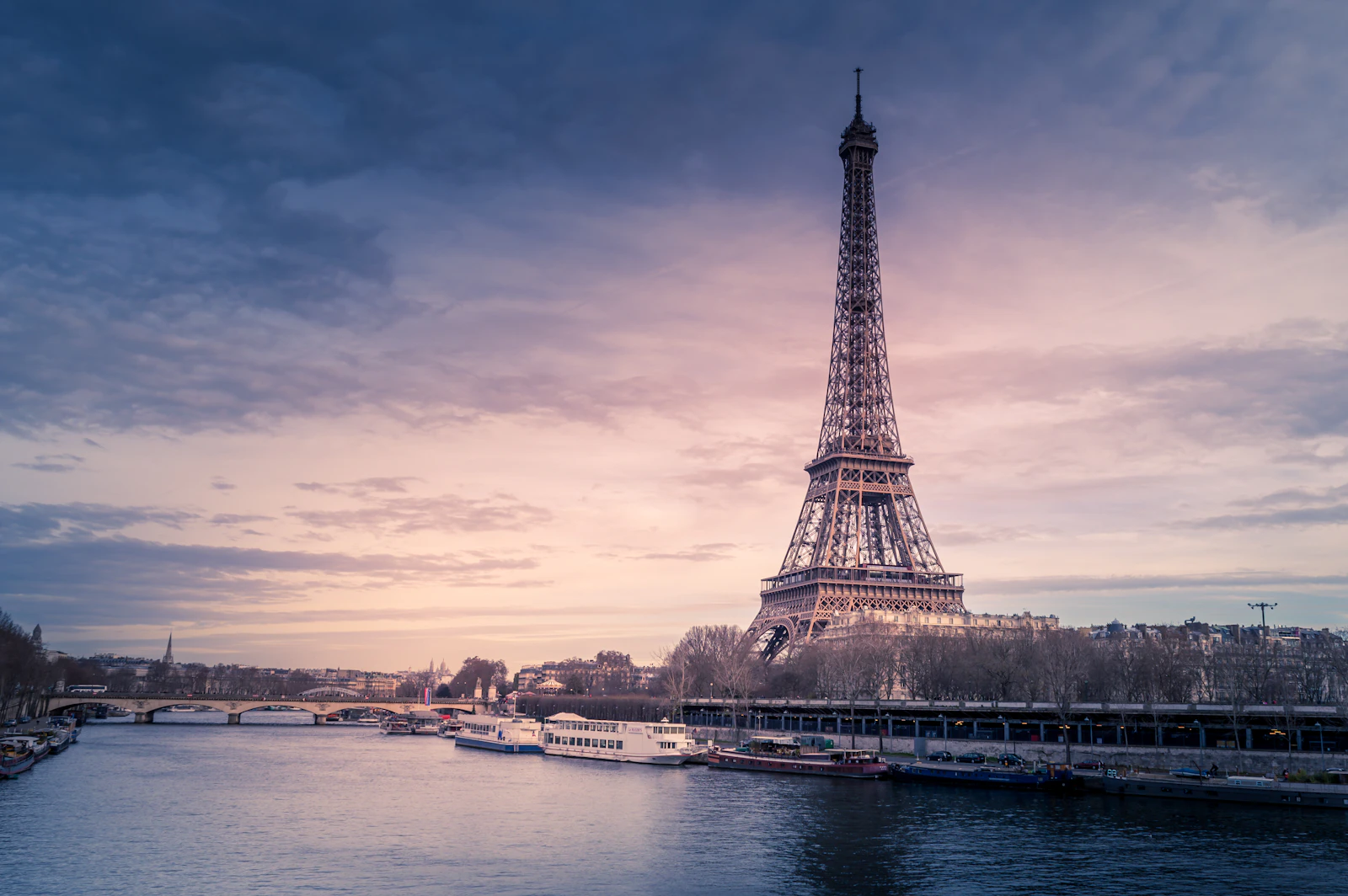 The Eiffel Tower beside the River Seine at dusk