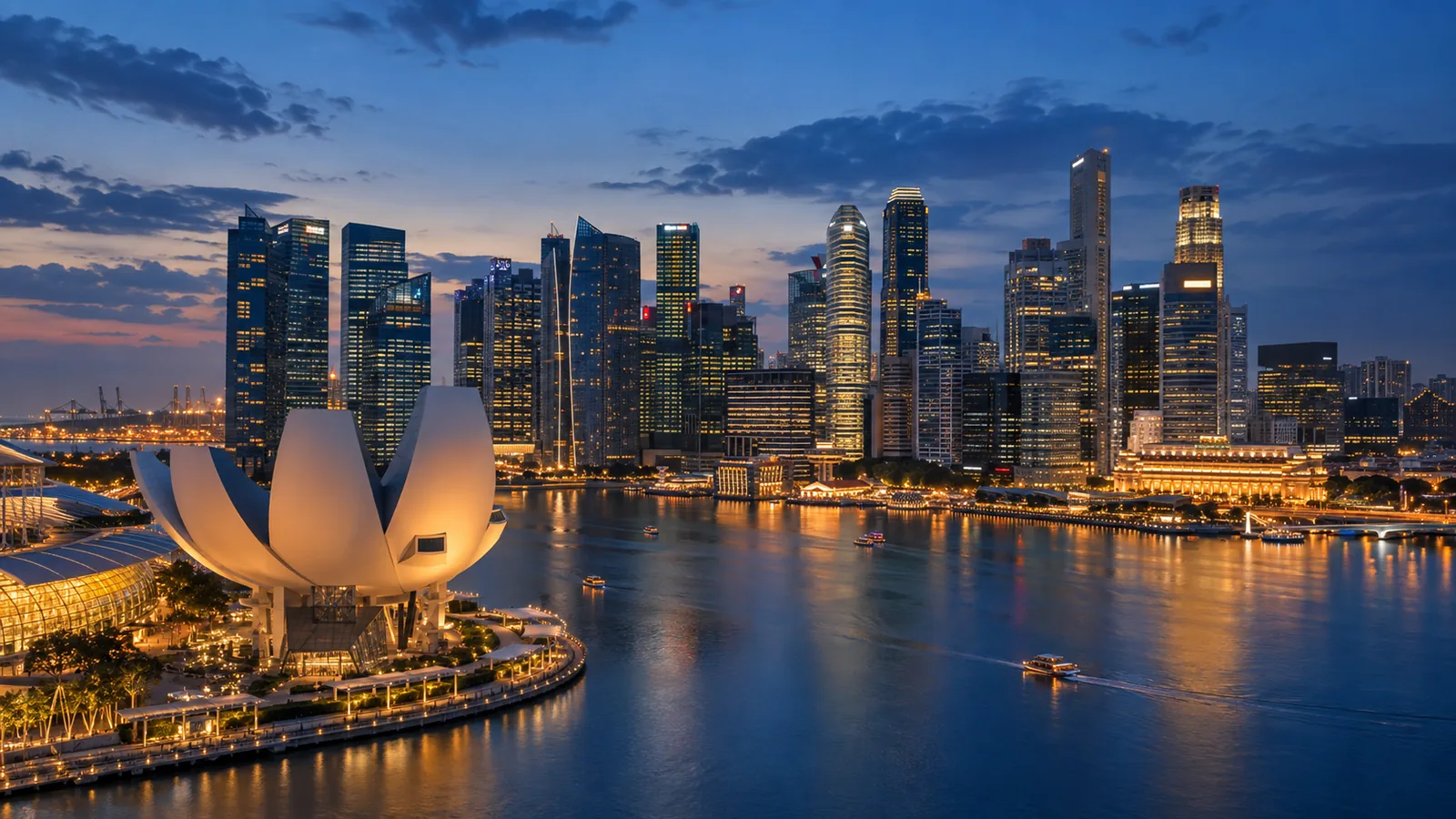 A modern waterfront city illuminated at blue hour